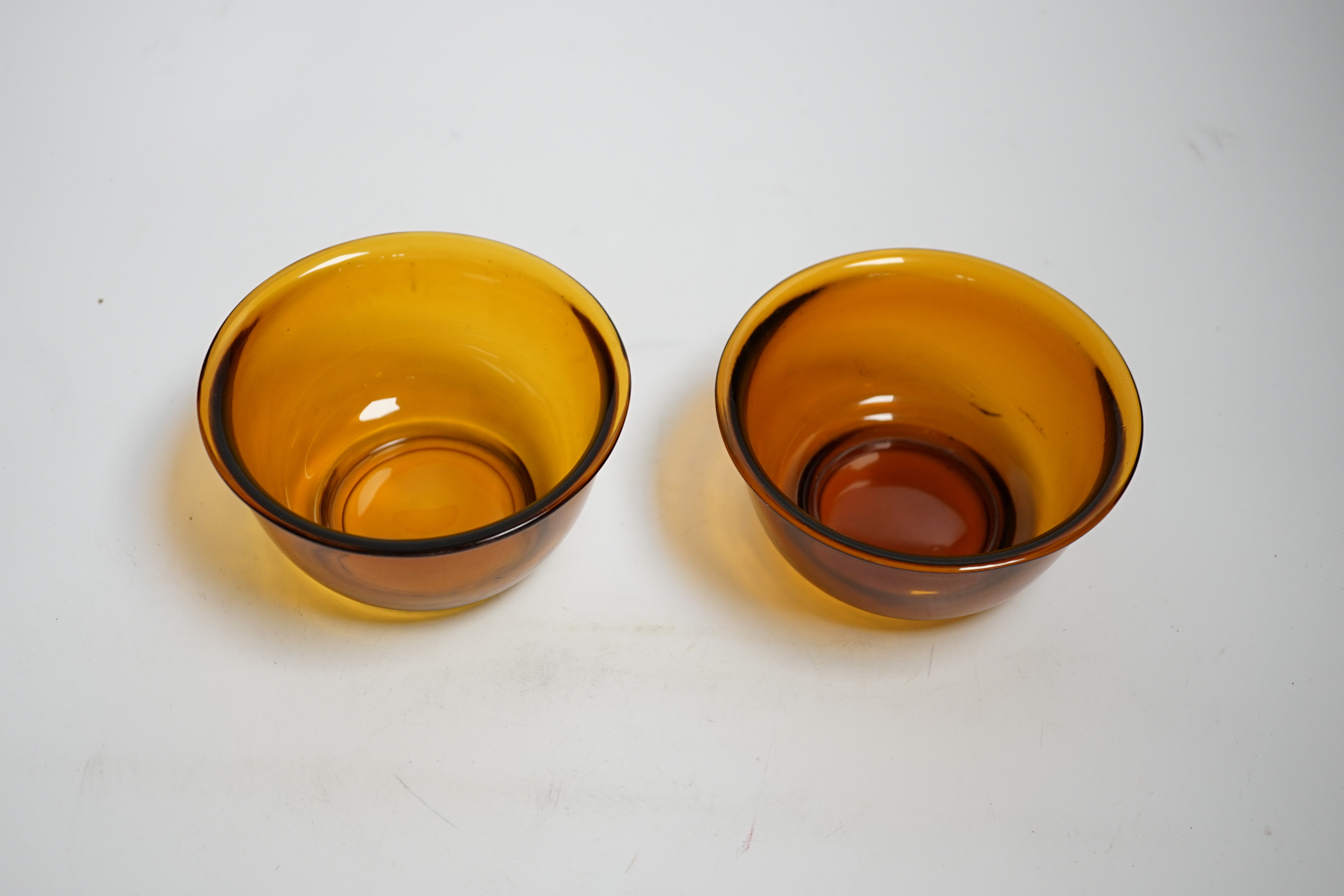 A pair of Chinese Beijing amber glass bowls, 11cm diameter